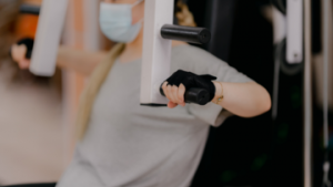 person-exercising-at-gym-with-mask-on